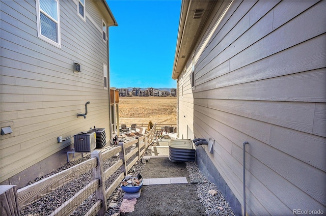 view of side of property with central air condition unit