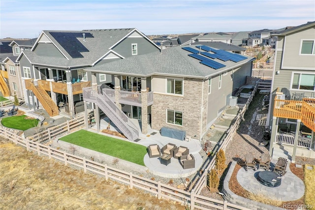 back of house with a patio, a fire pit, a fenced backyard, and stairs