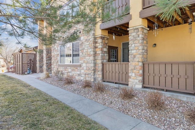 view of property exterior with stone siding and stucco siding