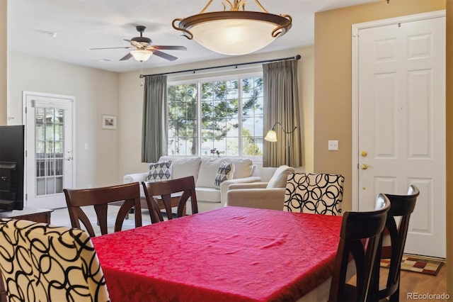 dining area with a ceiling fan and wood finished floors