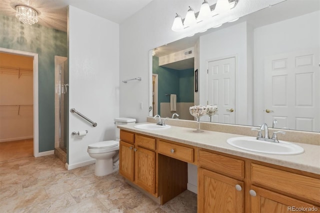 full bath featuring toilet, a shower stall, double vanity, and a sink