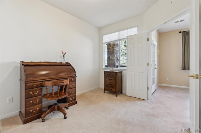 office space featuring light carpet, visible vents, and baseboards