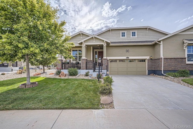 craftsman inspired home featuring brick siding, a porch, concrete driveway, an attached garage, and a front yard