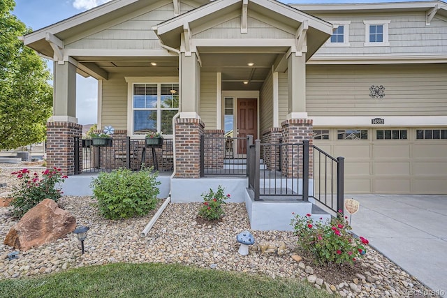 view of front of house with covered porch, concrete driveway, and brick siding