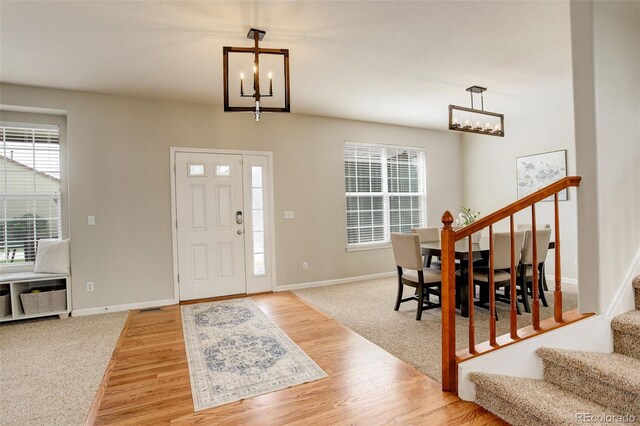 23427 Song Bird Hills Pl, Parker, CO 80138 - entryway featuring a chandelier, stairs, and plenty of natural light