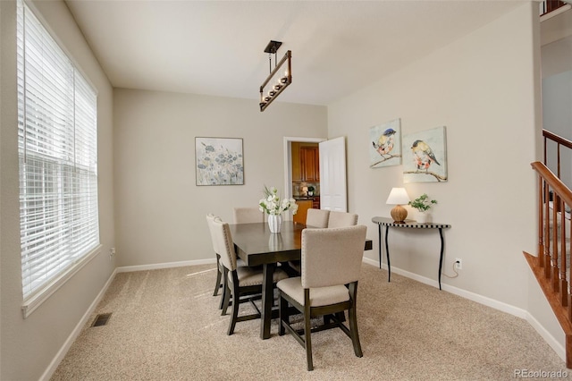 23427 Song Bird Hills Pl, Parker, CO 80138 - dining room with light carpet, baseboards, and stairs