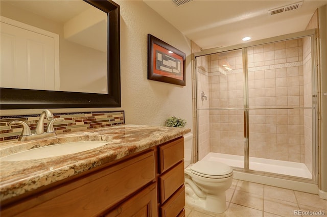 23427 Song Bird Hills Pl, Parker, CO 80138 - bathroom featuring toilet, vanity, a shower stall, and tile patterned flooring