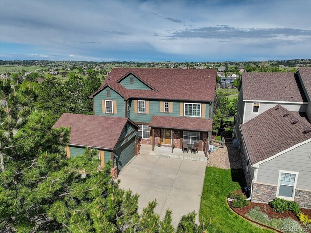 23427 Song Bird Hills Pl, Parker, CO 80138 - view of front of property featuring covered porch, roof with shingles, an outbuilding, a garage, and driveway