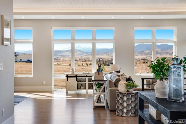 living area with recessed lighting, a mountain view, baseboards, and dark wood-type flooring