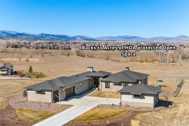 drone / aerial view with a rural view and a mountain view