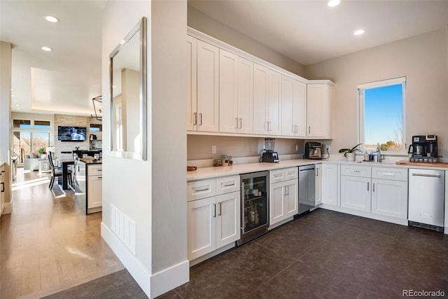 kitchen with dishwasher, wine cooler, visible vents, and white cabinets