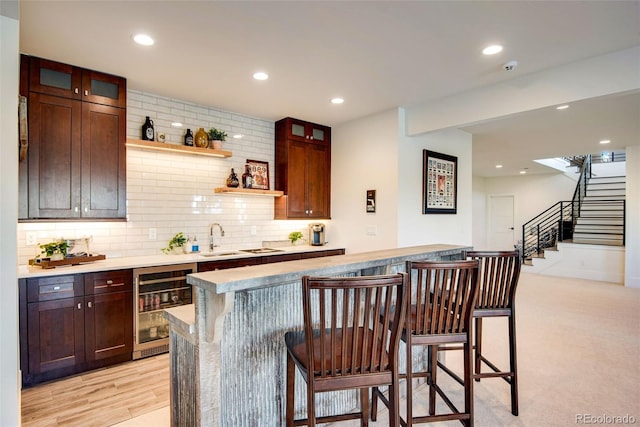 bar featuring beverage cooler, recessed lighting, tasteful backsplash, and stairs