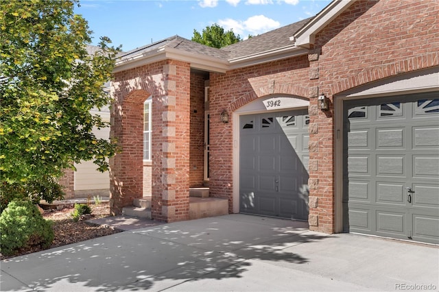 view of exterior entry with a garage