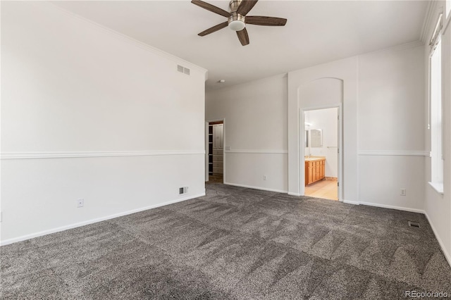 spare room with carpet floors, ornamental molding, and ceiling fan