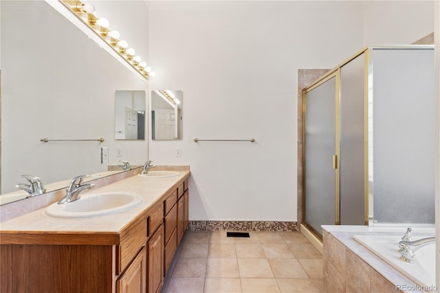 bathroom with tile patterned floors, vanity, and independent shower and bath