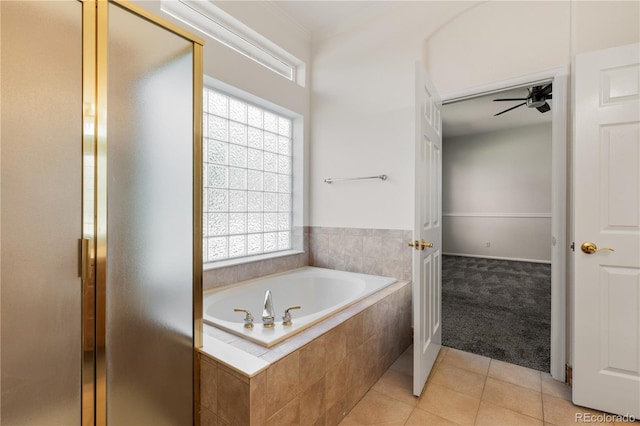 bathroom featuring ceiling fan, separate shower and tub, and tile patterned floors