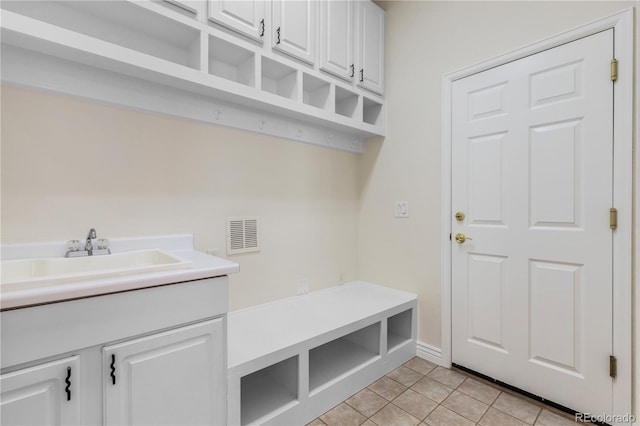 mudroom featuring sink and light tile patterned floors