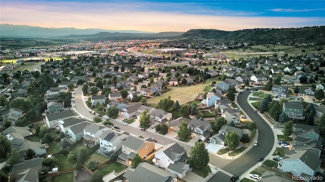 aerial view at dusk featuring a mountain view