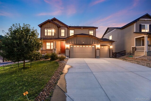 craftsman-style home with a garage and a yard