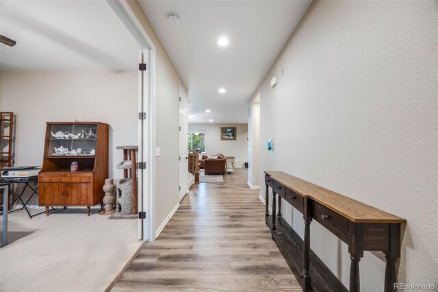 hall with hardwood / wood-style floors