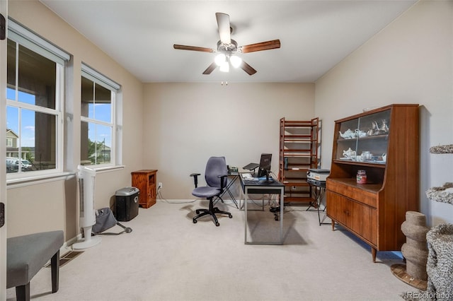 office space with ceiling fan and light colored carpet