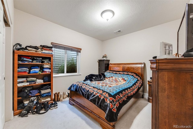 carpeted bedroom featuring a textured ceiling