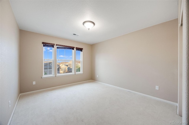 unfurnished room with light carpet