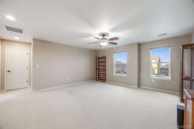 empty room with light colored carpet and ceiling fan