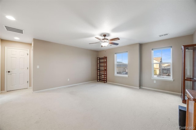 carpeted spare room with ceiling fan