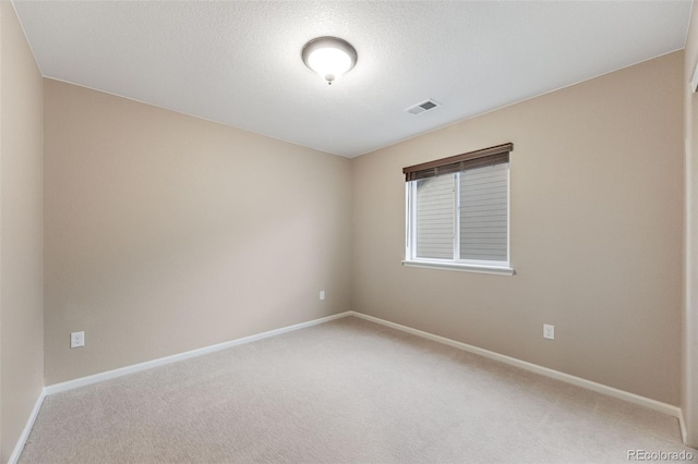 empty room featuring carpet floors and a textured ceiling