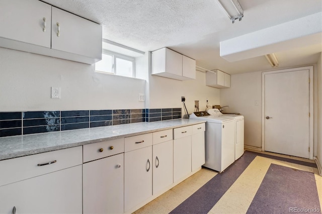 2196 W 56th Ave, Denver, CO 80221 - laundry area featuring cabinet space, washing machine and clothes dryer, light floors, and a textured ceiling