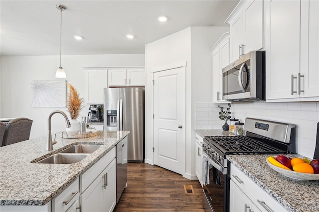 kitchen with a sink, dark wood finished floors, white cabinetry, and stainless steel appliances