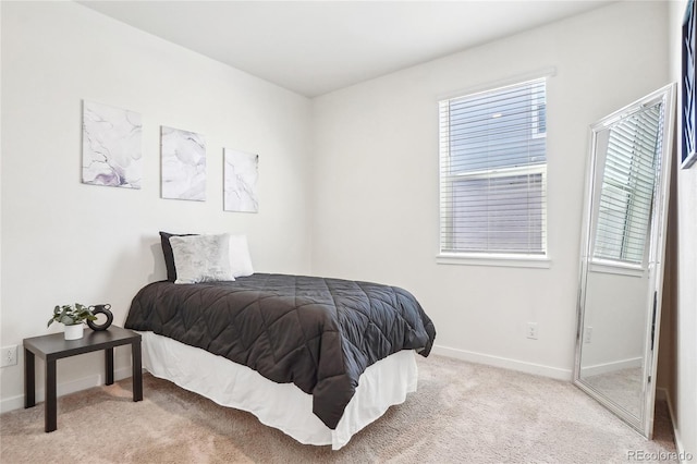 carpeted bedroom with baseboards