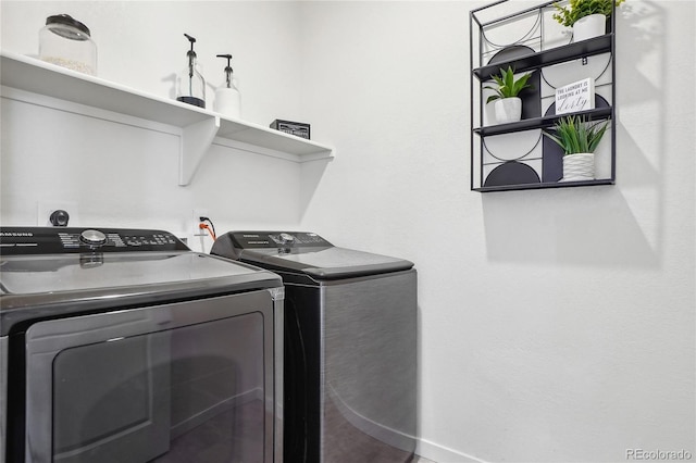 washroom featuring washing machine and dryer and laundry area