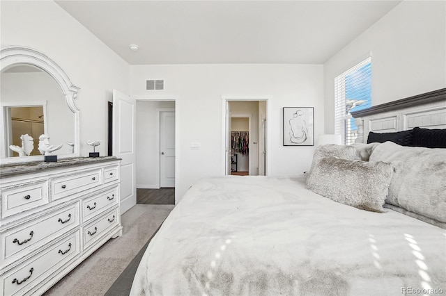 bedroom featuring visible vents and a walk in closet