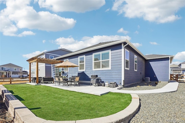 rear view of property featuring fence, central AC unit, a yard, a patio area, and a pergola