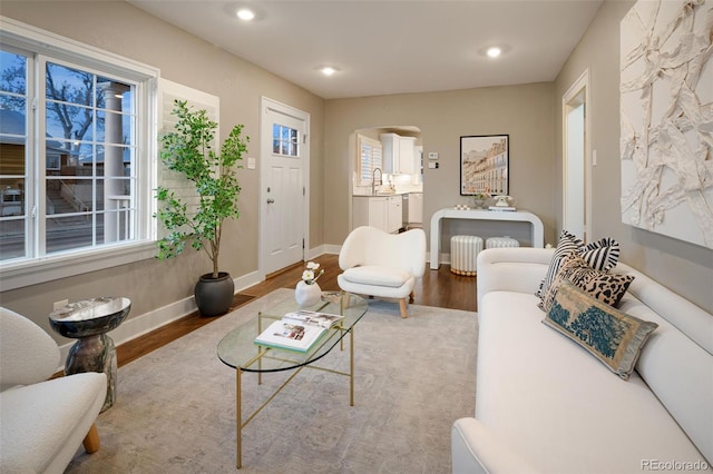 living room with recessed lighting, wood finished floors, and baseboards