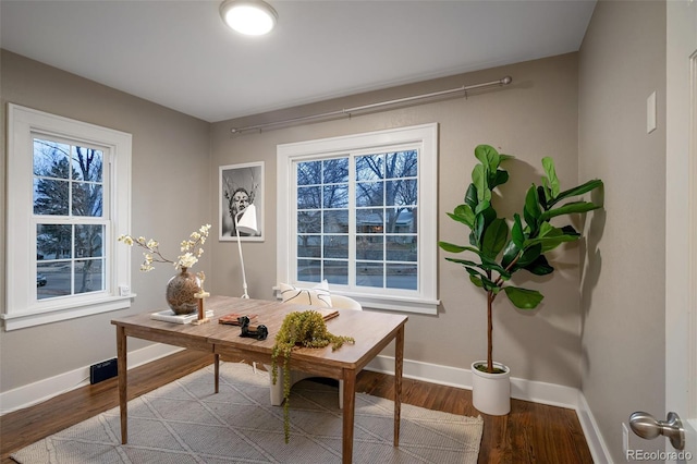 office space with baseboards and wood finished floors