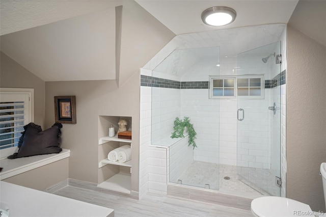 full bath featuring toilet, a shower stall, and vaulted ceiling