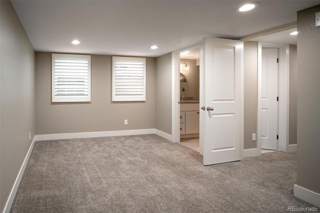 interior space with light carpet, recessed lighting, and baseboards