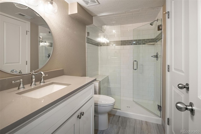 full bath with visible vents, a stall shower, toilet, and a textured wall