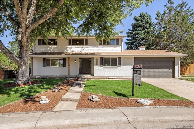 view of property with a garage and a front yard