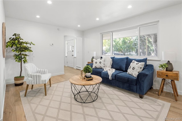 living room featuring light hardwood / wood-style floors and a baseboard radiator