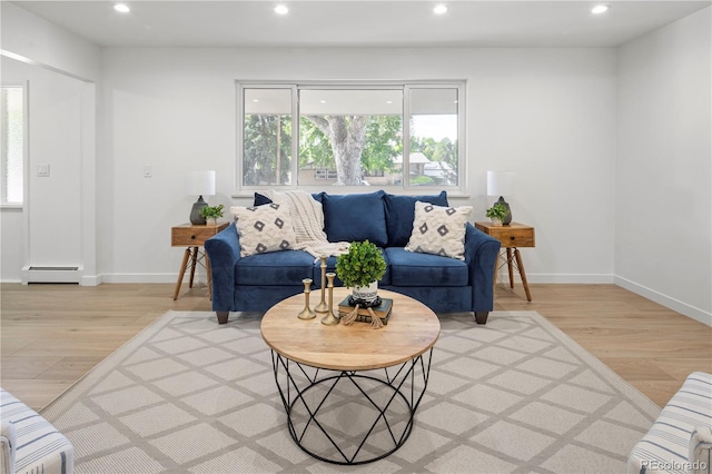 living room featuring a baseboard radiator and light wood-type flooring