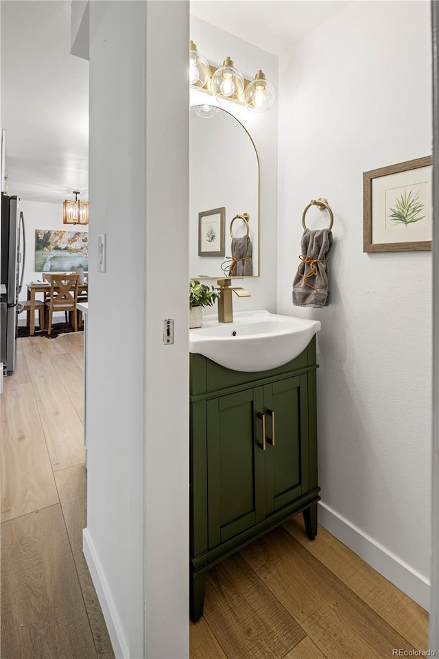 bathroom featuring wood-type flooring and vanity