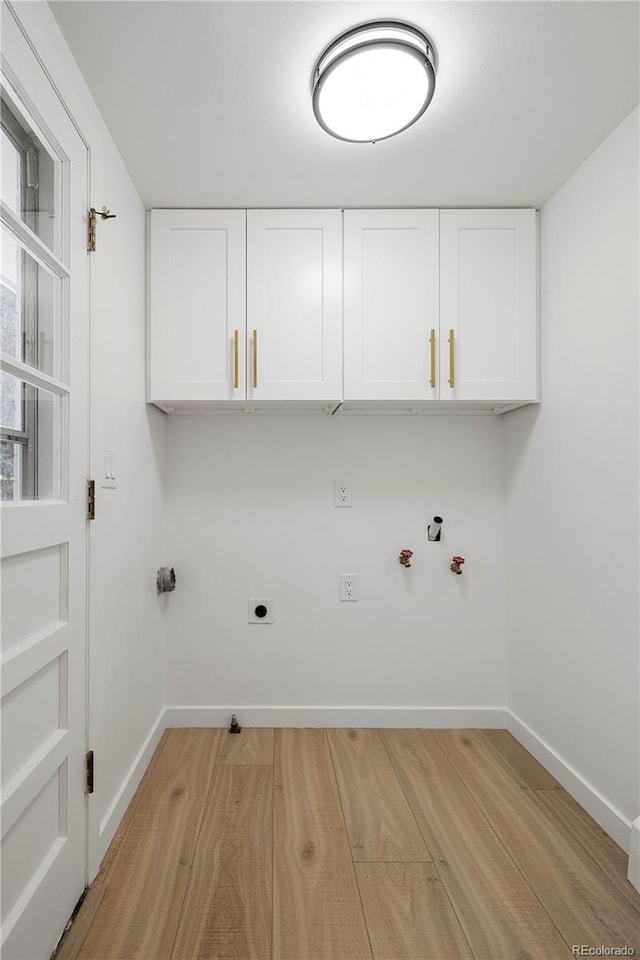 clothes washing area featuring hookup for a washing machine, cabinets, gas dryer hookup, and electric dryer hookup