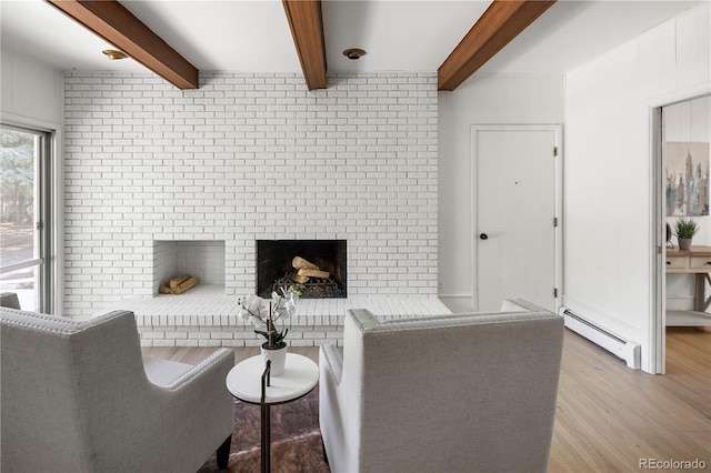 living room featuring wood-type flooring, a baseboard radiator, a brick fireplace, brick wall, and beamed ceiling