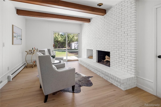 living room featuring a brick fireplace, light hardwood / wood-style floors, a baseboard heating unit, and beamed ceiling