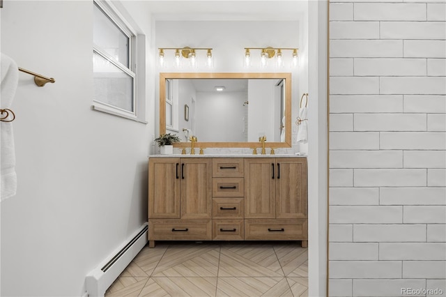 bathroom featuring a baseboard heating unit and vanity