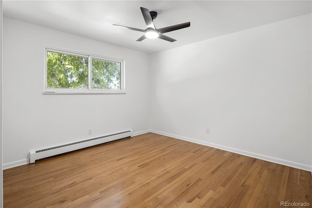 empty room featuring light hardwood / wood-style floors, ceiling fan, and a baseboard radiator